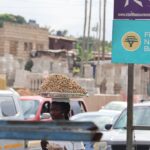 A street scene with focus on a sign - FintechFalcon.com